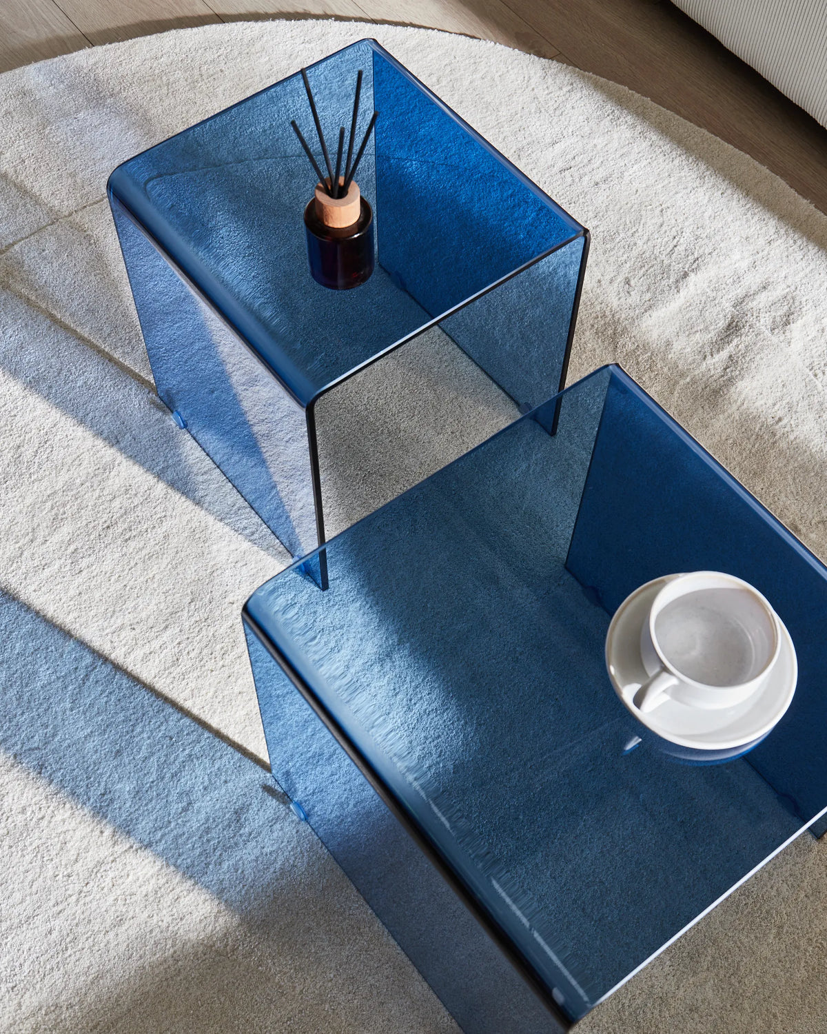 Set of 2 Side Tables TRENTO Tempered Glass Blue — angled product view